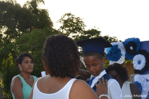 CVFL's Co-Founder Joli pinning Giovanny on the graduation stage